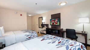 A hotel room with two beds, a television, a desk with a lamp, and a chair. - Red Roof Inn Gaffney (Gaffney)