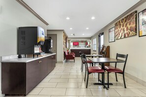 A modern restaurant with a counter, seating area, and a visible menu board. - Red Roof Inn West Memphis, AR (West Memphis)