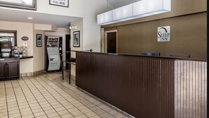 A hotel reception area with a counter, a refrigerator, and a sign indicating a Sleep Inn. - Sleep Inn Gaffney at I-85 (Gaffney)