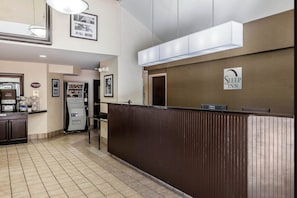 A hotel reception area with a counter, a refrigerator, and a sign indicating a Sleep Inn. - Sleep Inn Gaffney at I-85 (Gaffney)