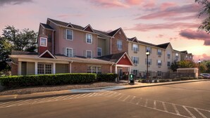 A multi-story residential building with a brick facade, multiple windows, and a gated entrance. - MainStay Suites Houston NASA/Clear Lake (Houston)