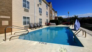 A swimming pool with a 'NO DIVING' sign, a '3 FT' depth marker, and a 'NO TRESPASSING' sign. - Siegel Select Montgomery (Montgomery)