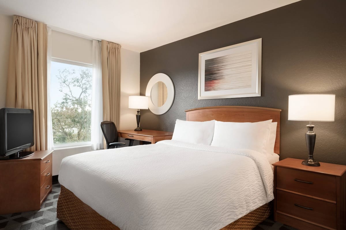 Premium bedding, desk, laptop workspace, blackout drapes
