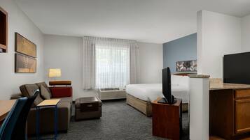 Hypo-allergenic bedding, desk, laptop workspace, blackout drapes