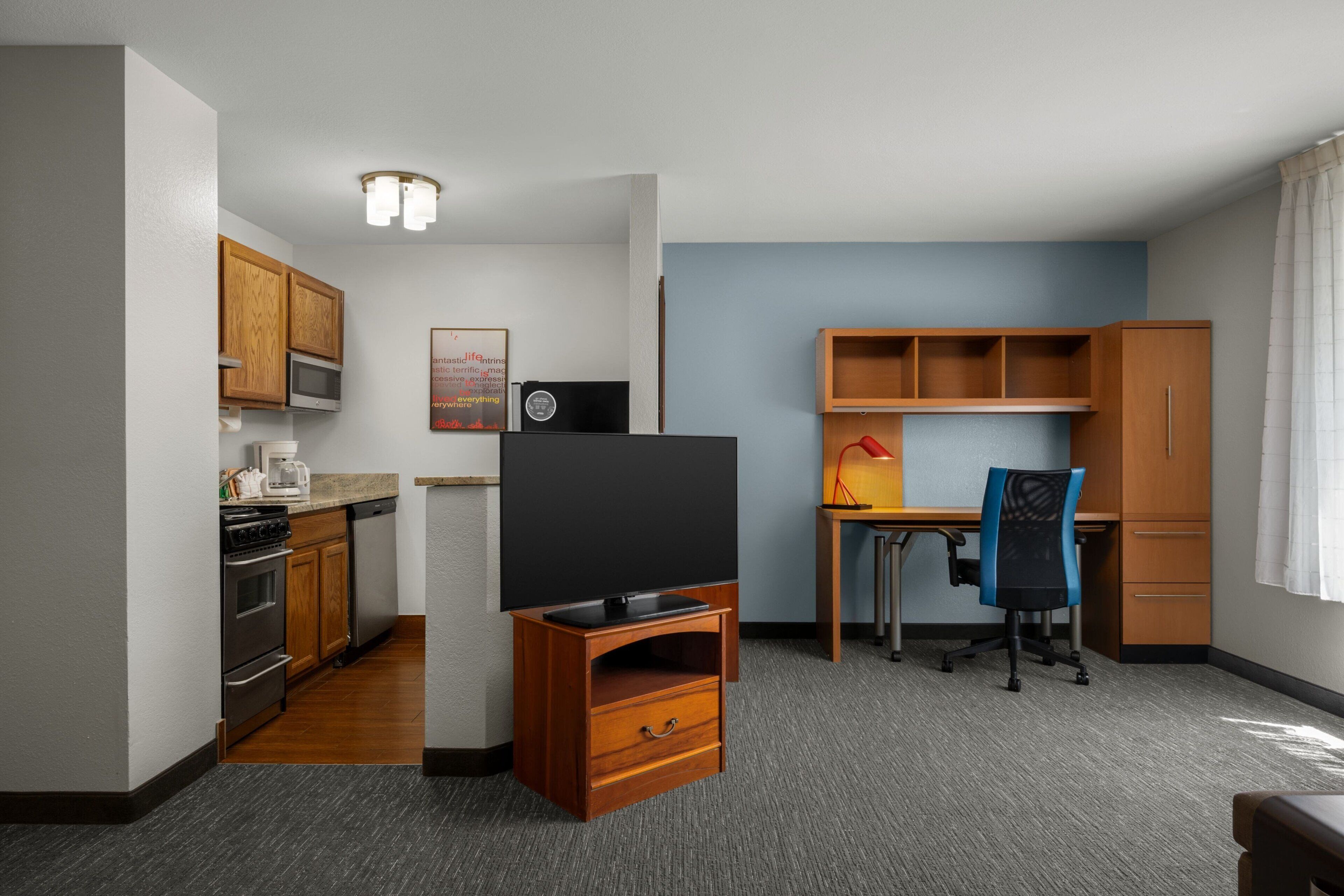 hypo-allergenic bedding, desk, laptop workspace, blackout curtains