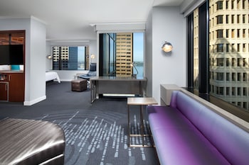 A high-rise building with a distinctive pyramid-shaped top, surrounded by other tall buildings. at W Seattle