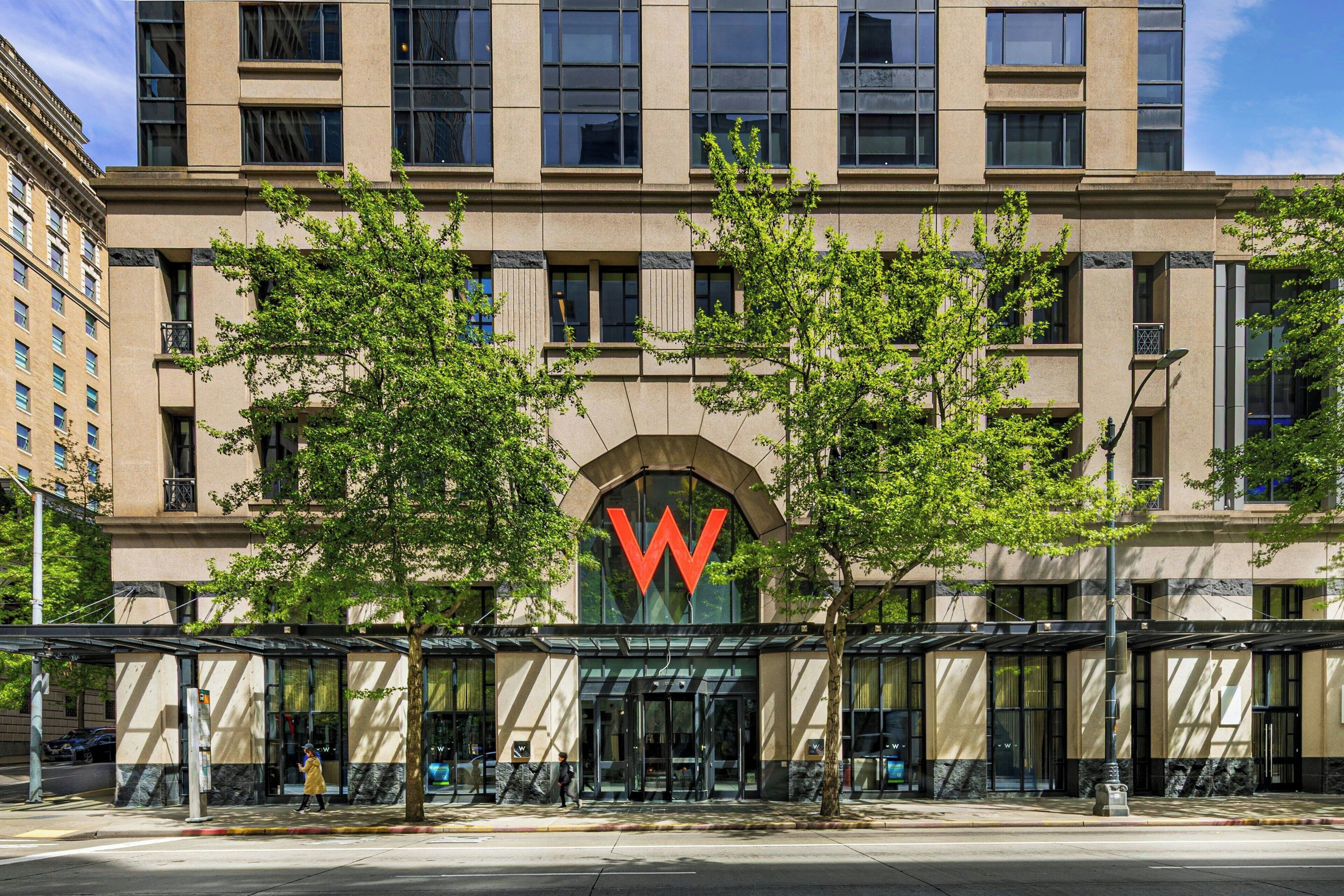 A building with a prominent 'W' logo, large windows, and a covered entrance area.