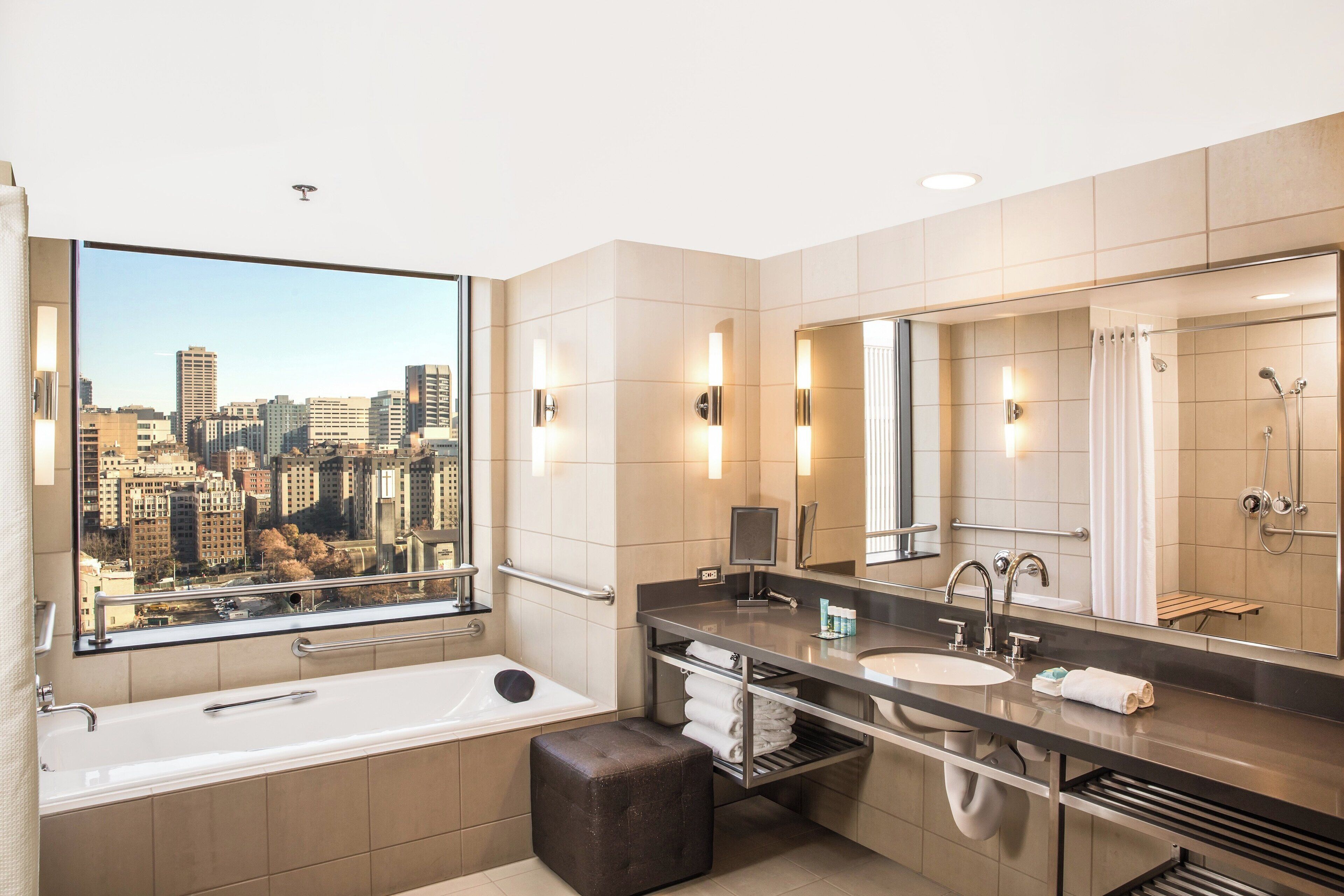 superior suite, 1 king bed, city view, corner | bathroom | combined shower/bathtub, designer toiletries, hair dryer, bathrobes