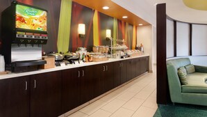 A modern kitchen area with a coffee machine, a microwave, and various food items on the counter. - Springhill Suites Memphis East / Galleria (Memphis)