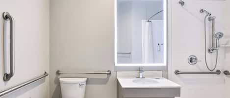 A modern bathroom with a toilet, sink, and shower.