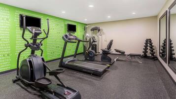 A gym with treadmills, an elliptical, and weight equipment.