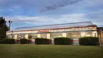 A diner with a large, sloped roof and a sign reading "Penny's Diner."