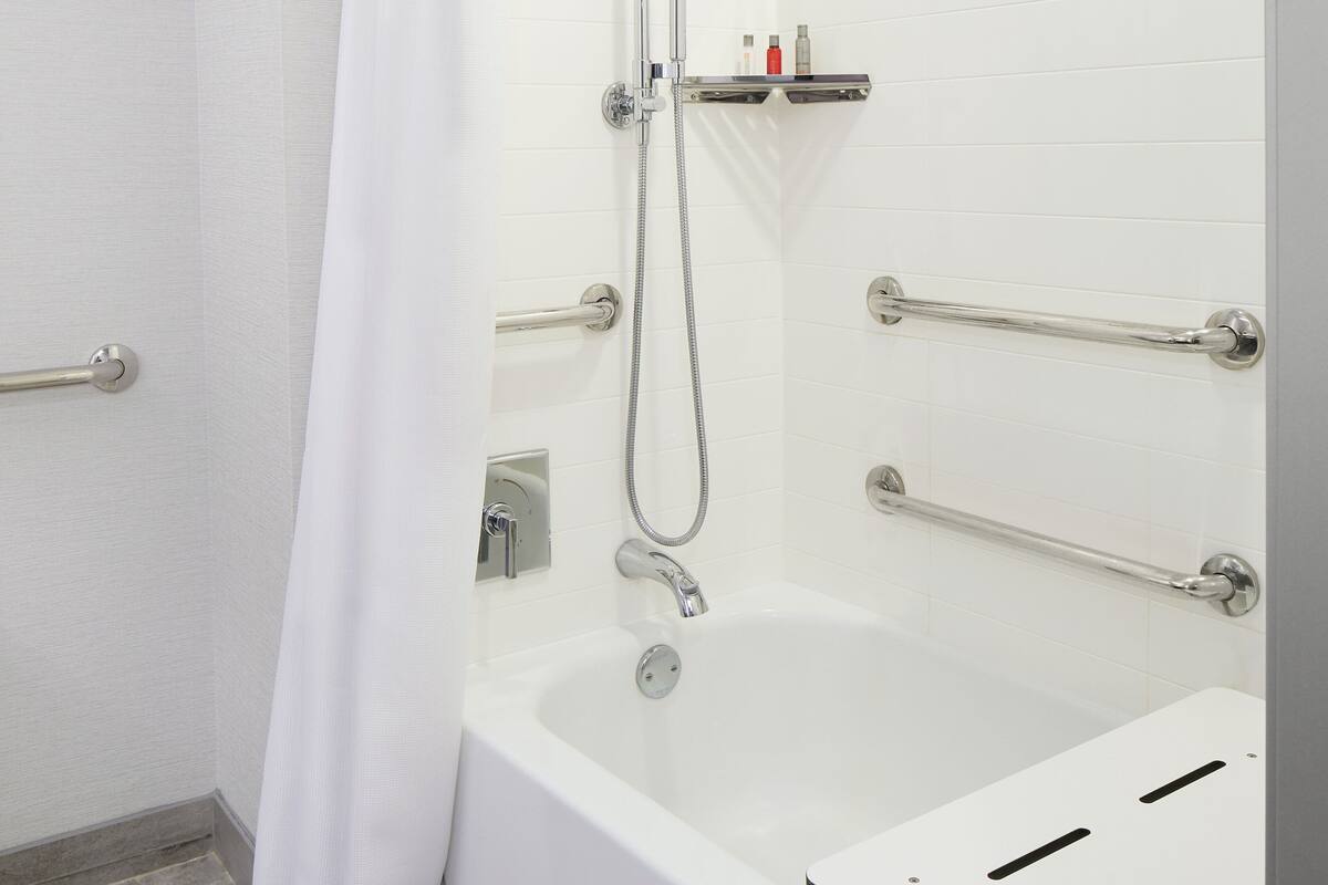 combined shower/bathtub, designer toiletries, hair dryer, towels