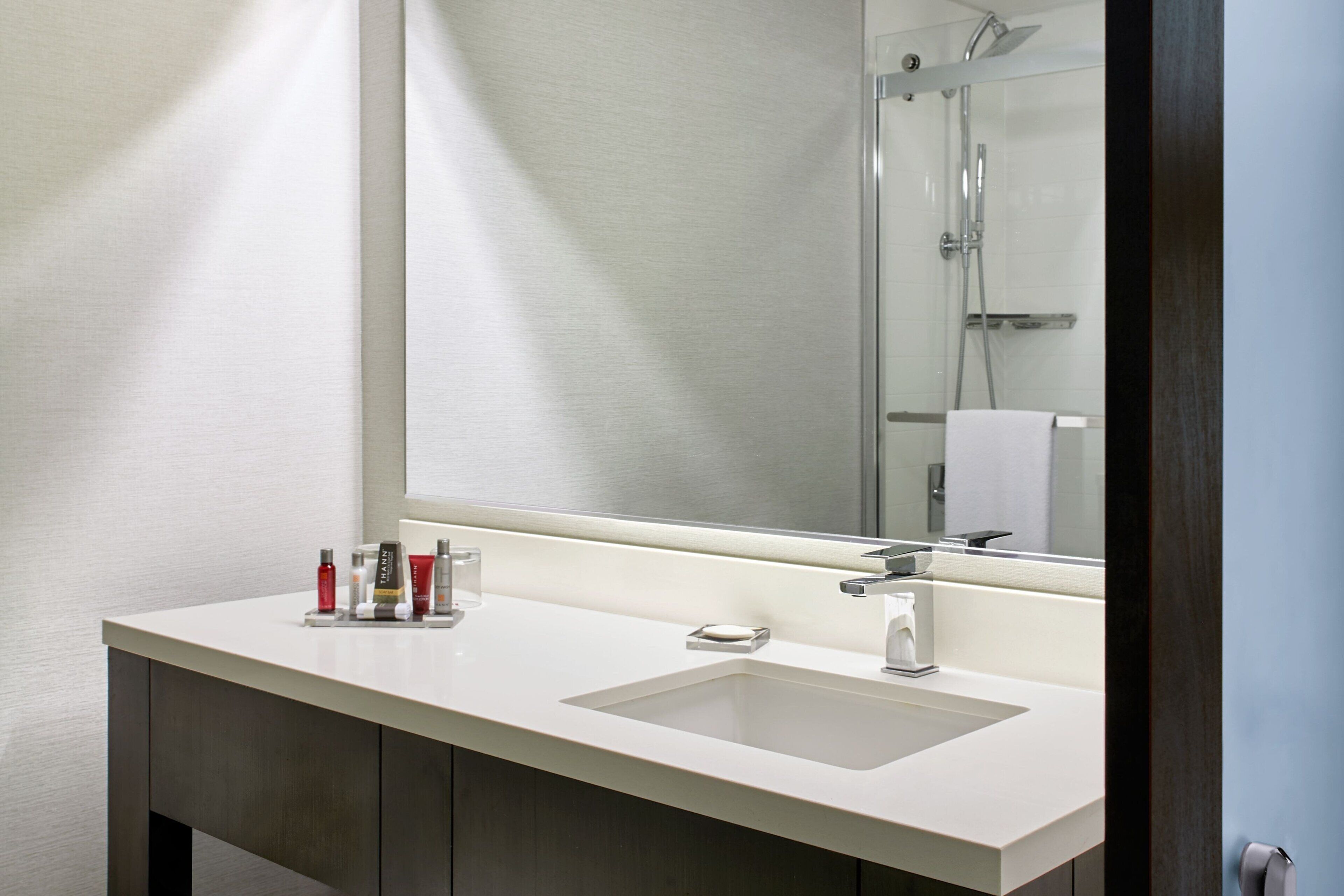 combined shower/bathtub, designer toiletries, hair dryer, towels