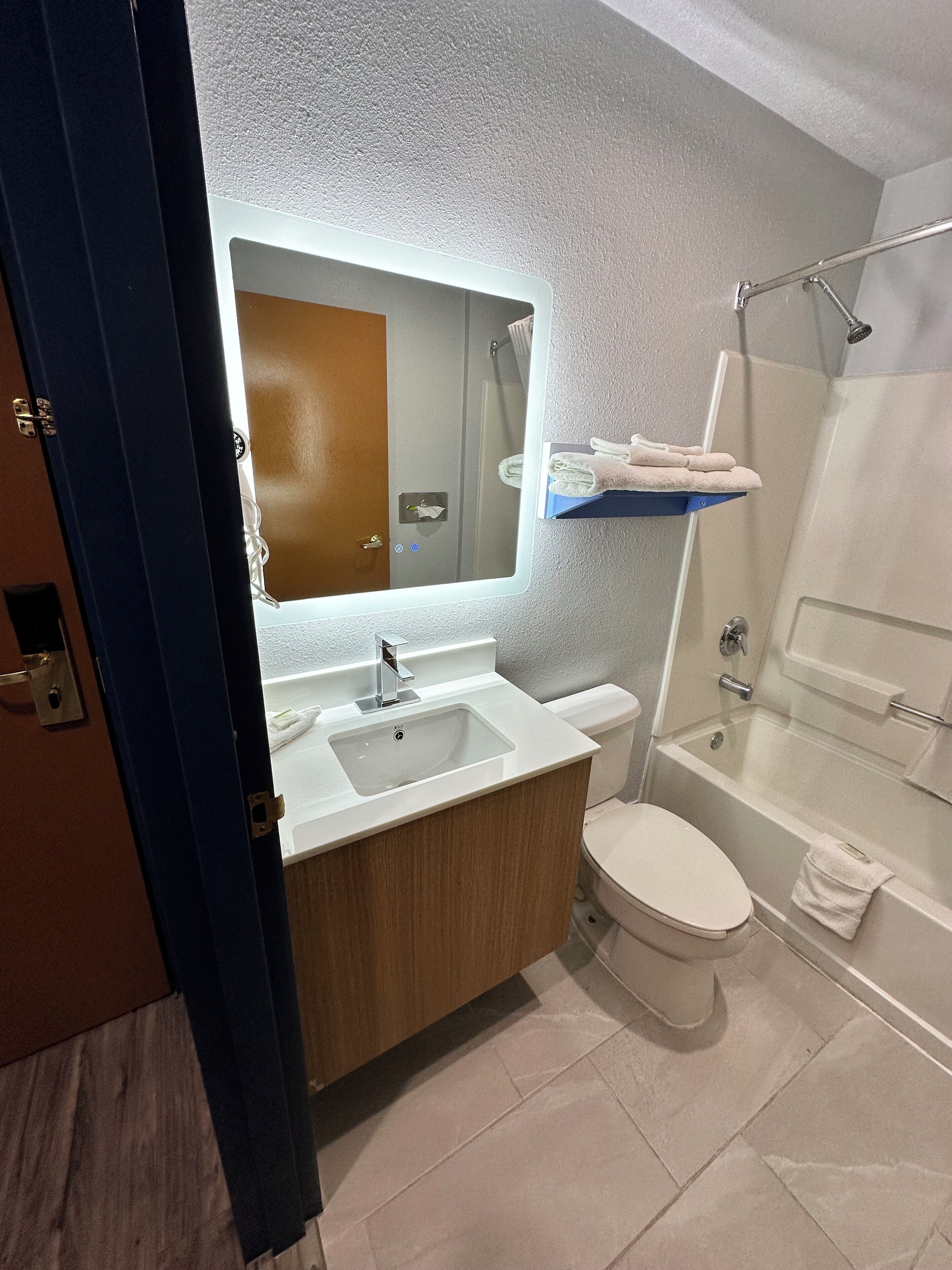 A bathroom with a sink, toilet, and bathtub.