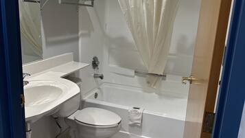 A bathroom with a sink, toilet, and bathtub.