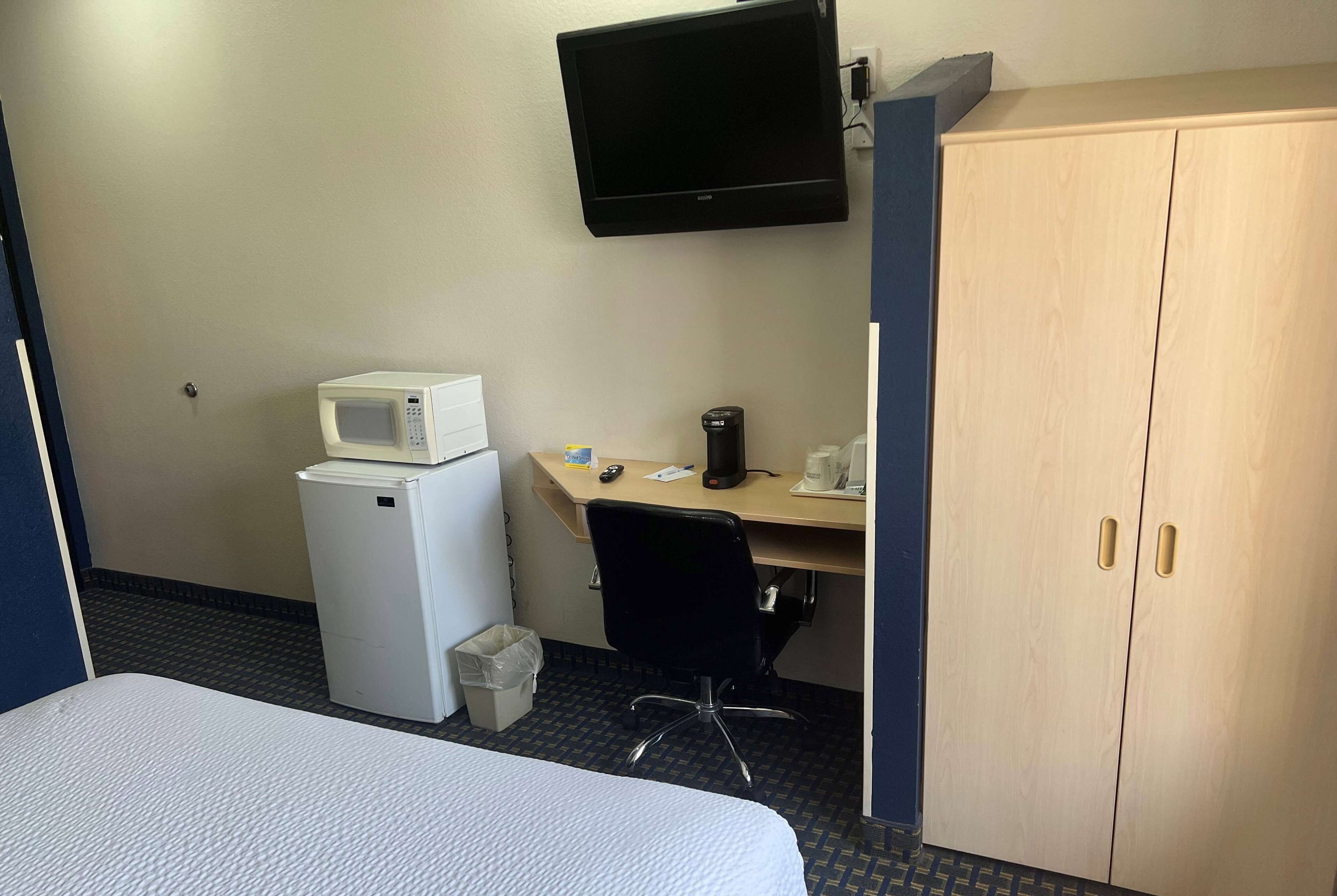 Escritorio, cortinas blackout y tabla de planchar con plancha 