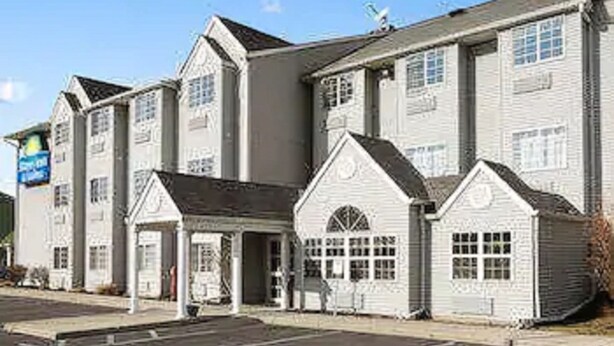 A two-story building with a central entrance and a small porch.