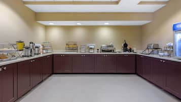 A kitchen area with cabinets, a coffee station, and a toaster.