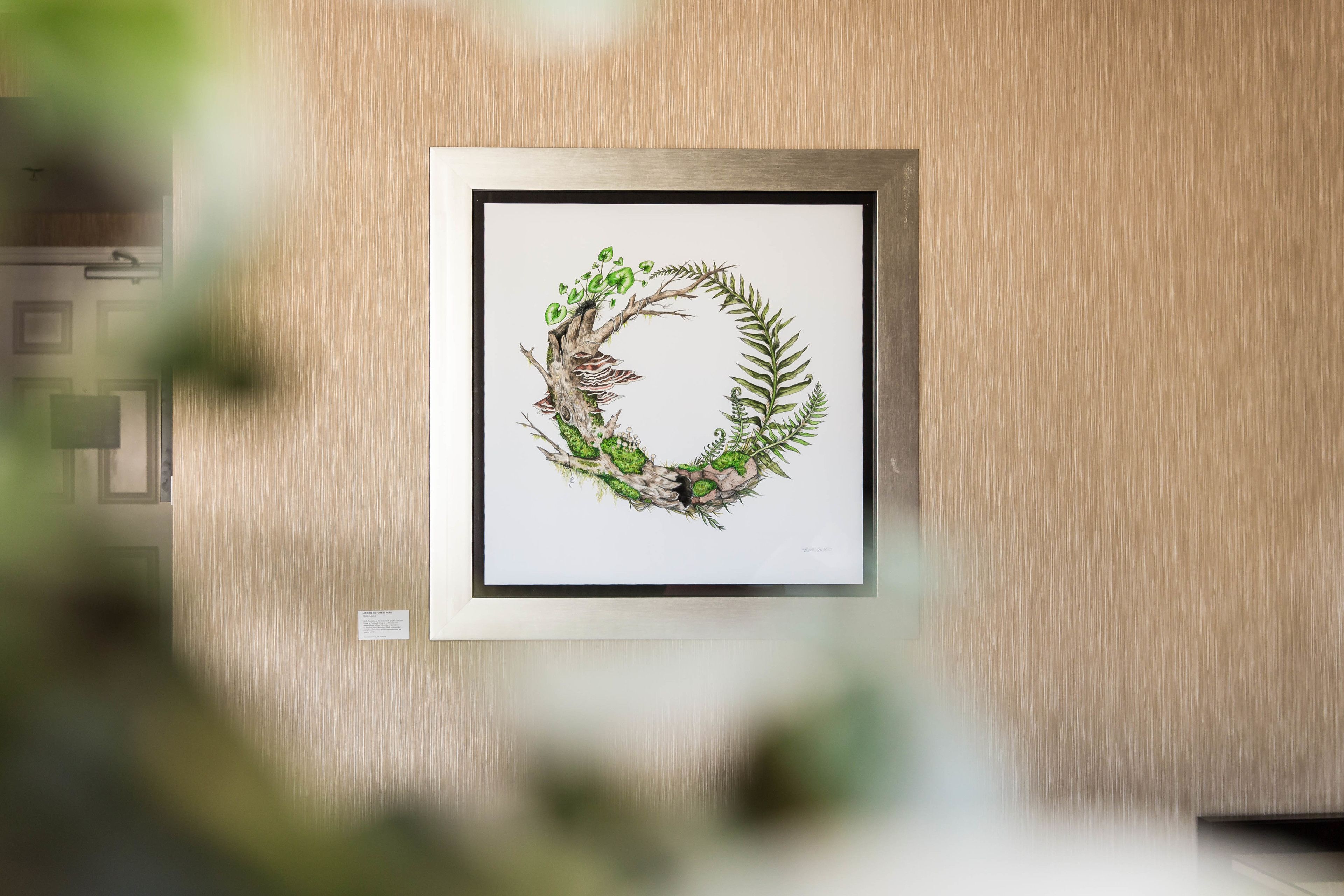 A framed artwork of a wreath on a wooden wall.