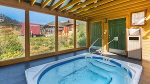 A hot tub with a view of mountains and a wooden ceiling. - Best Western Rivers Edge (Red River)