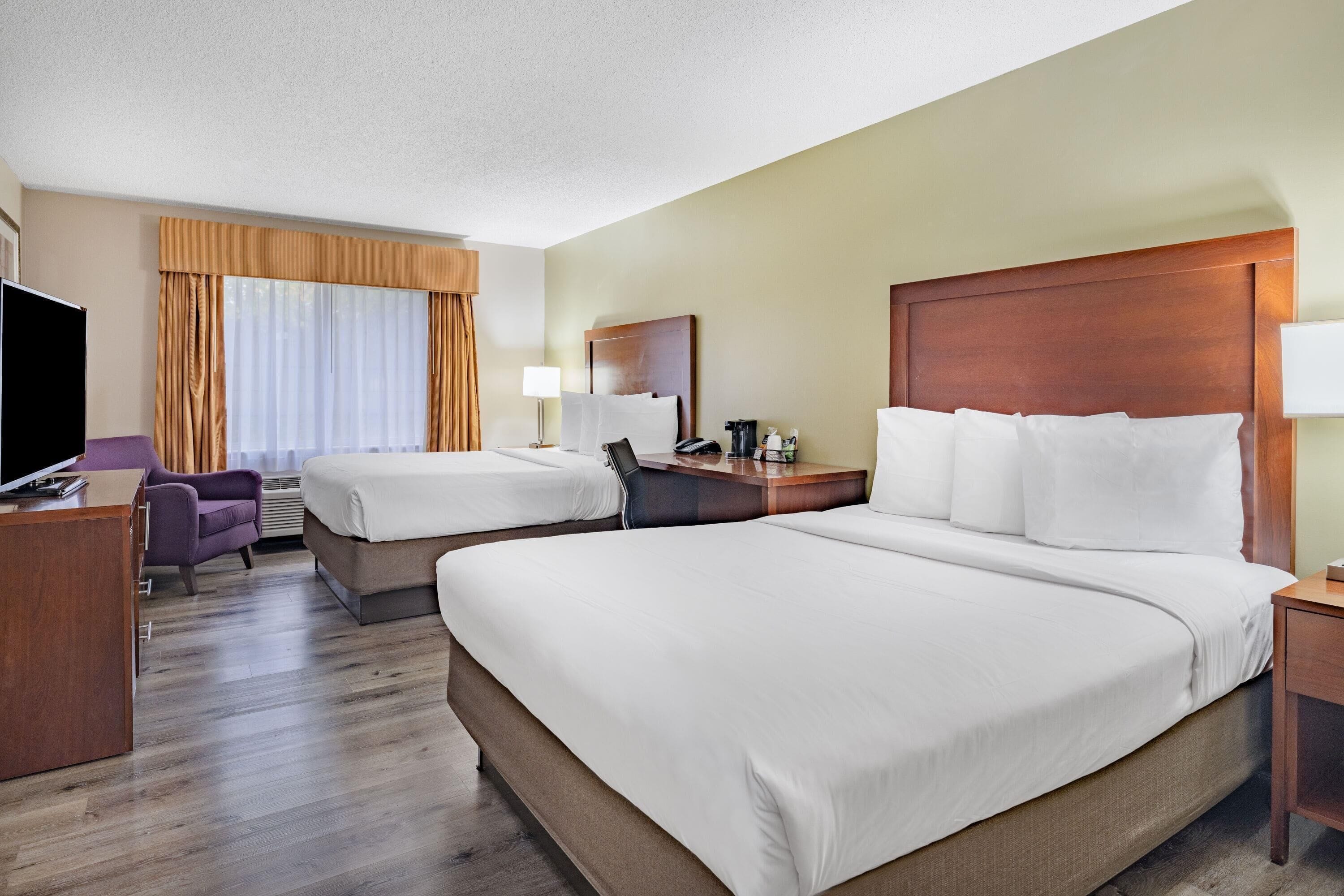 Premium bedding, pillow-top beds, desk, laptop workspace