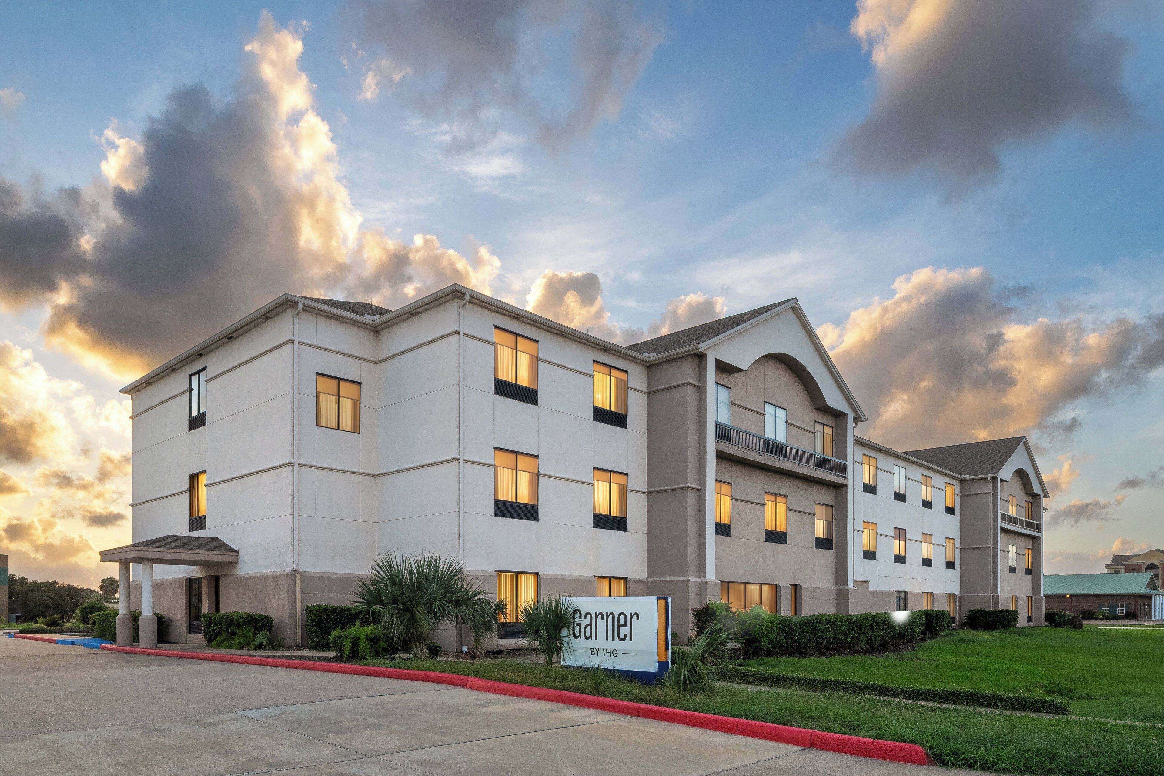 A hotel with a modern design, featuring multiple floors and a flat roof.