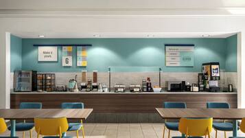 Een modern café met een balie, een zitgedeelte en diverse stations voor eten en drinken.