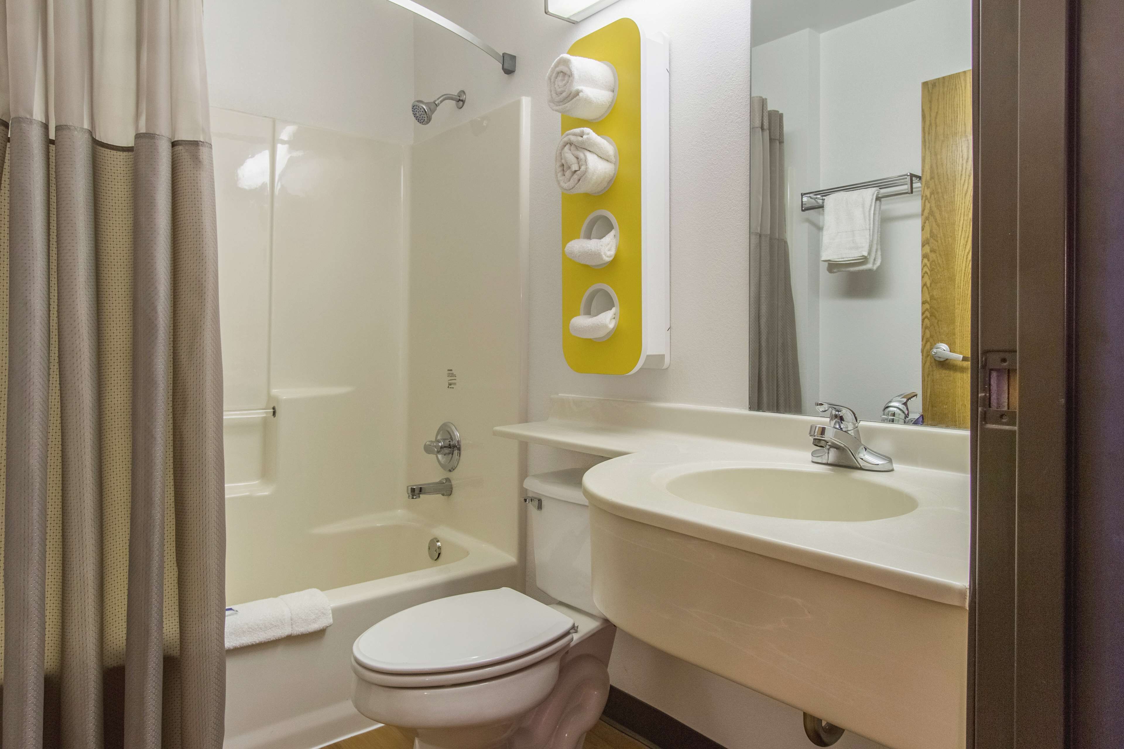 A bathroom with a bathtub, toilet, sink, and a shower.