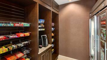 A snack bar with various packaged snacks and a coffee machine.
