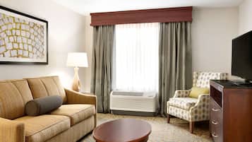 Suite, 1 King Bed, Jetted Tub | Living area | 43-inch TV with cable channels