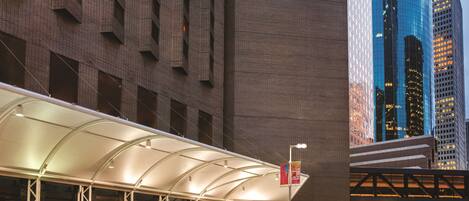 A Hyatt Regency hotel with a modern design, featuring a prominent glass facade and a covered entrance area.
