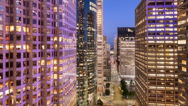 A high-rise building with multiple floors, large windows, and a central courtyard. - Hyatt Regency Houston Downtown (Houston)