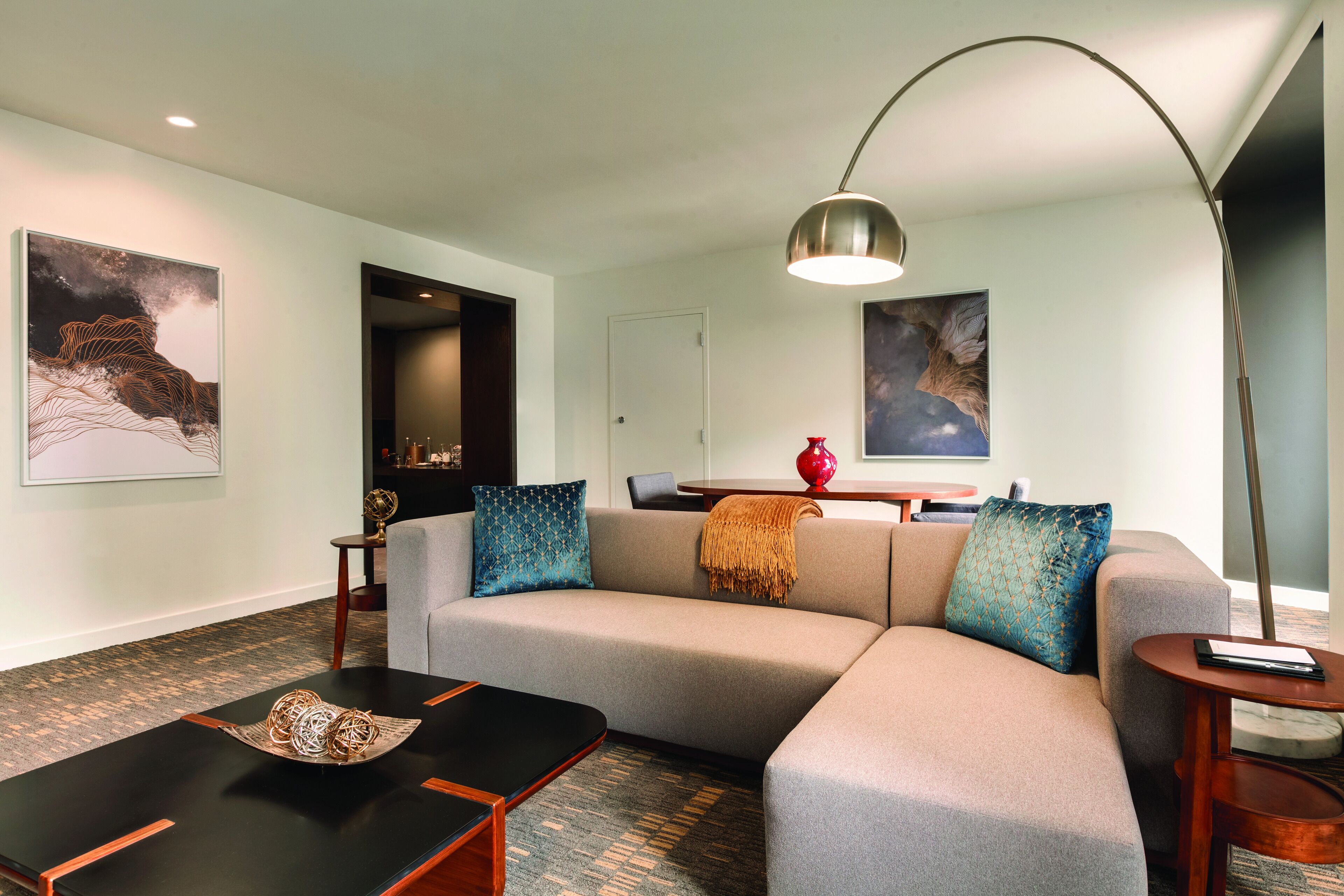 A modern living room with a sofa, coffee table, and a floor lamp.