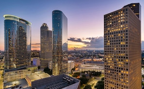 A high-rise building with a modern architectural design, featuring a curved facade and multiple floors.