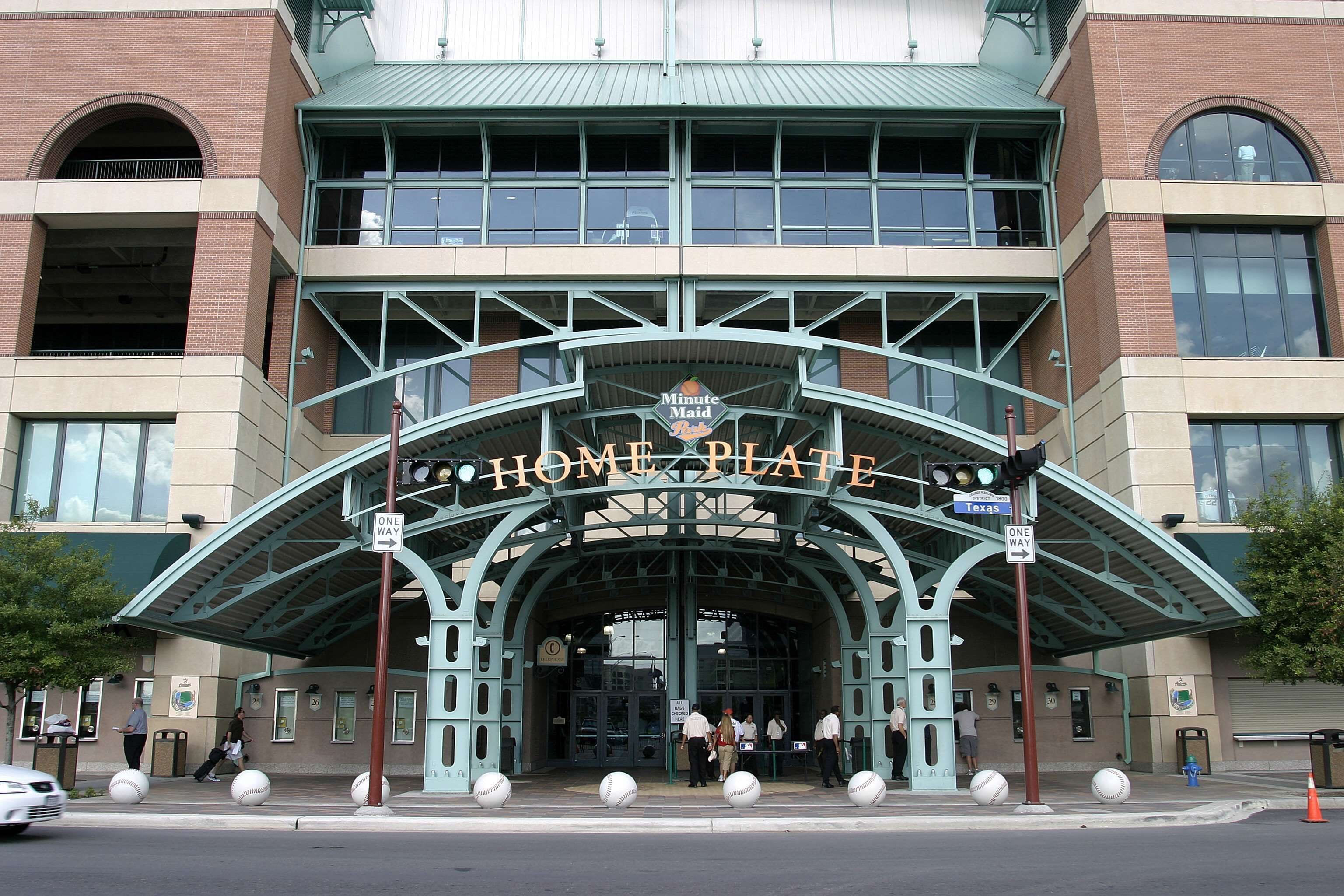 A building with a large arched entrance labeled 'Minute Maid Park' and 'Home Plate.'