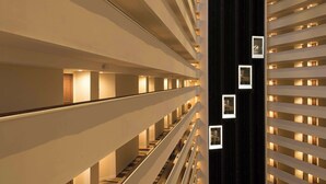 A multi-level interior with a central staircase, illuminated by recessed lighting. - Hyatt Regency Houston Downtown (Houston)
