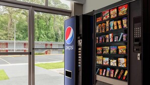 A vending machine with a Pepsi logo, stocked with various snacks and beverages.