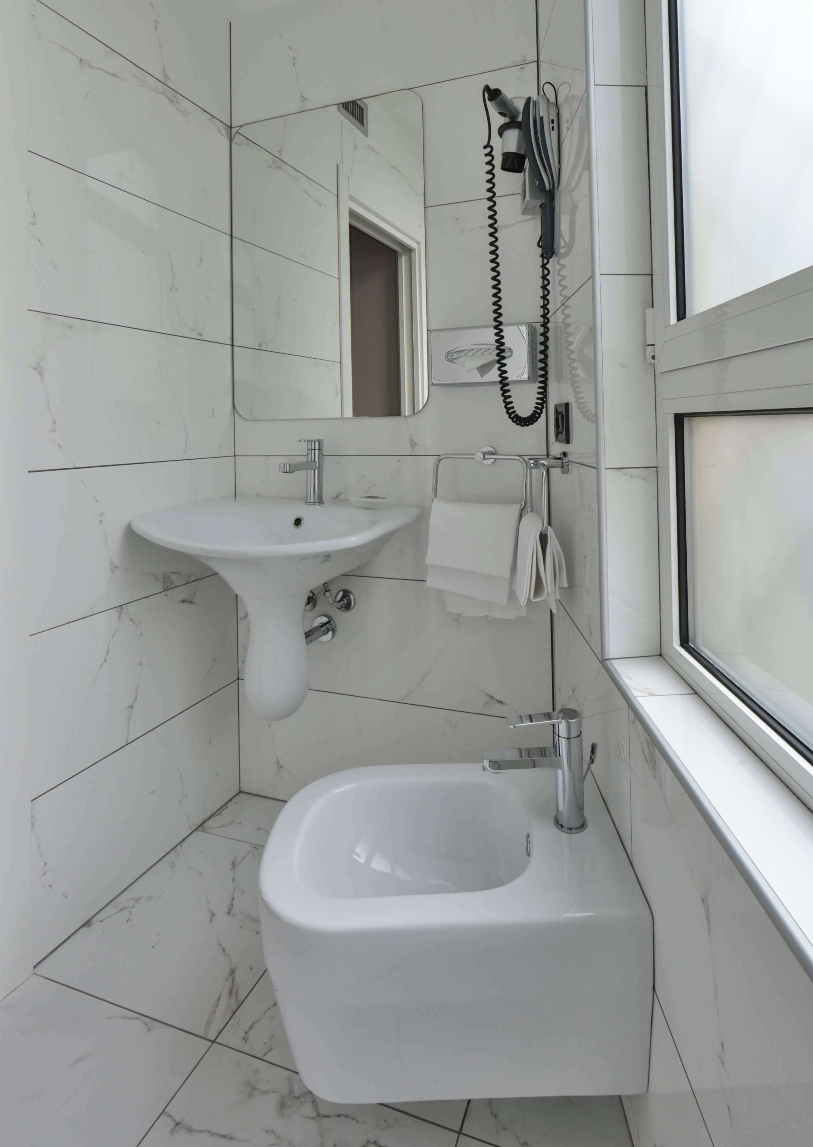 comfort room, multiple beds | bathroom | hair dryer, bidet, towels