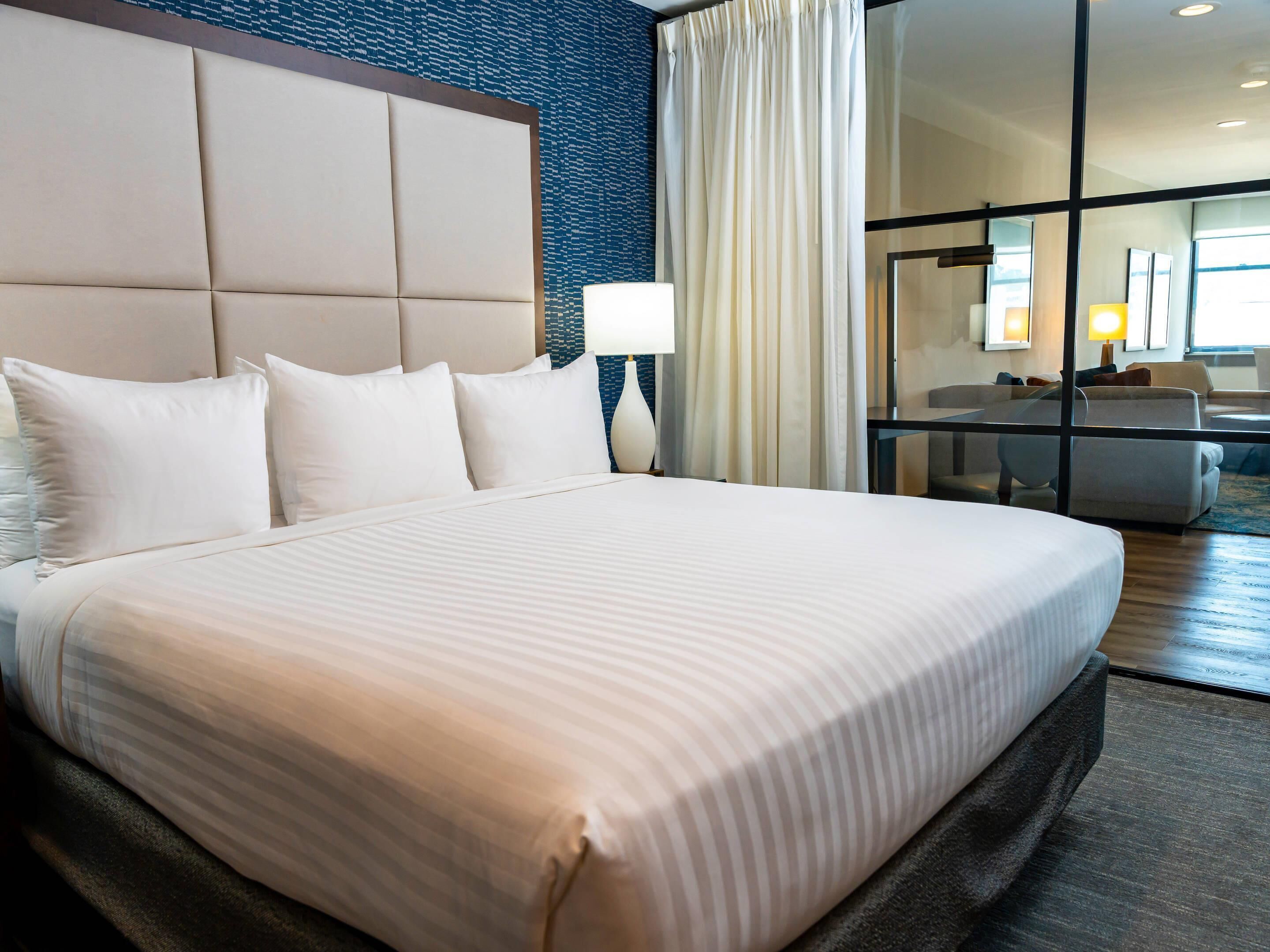 Deluxe City View Suite, 1 King Bed with Sofa Bed, Separate Living/Ding Area, Shower only | Egyptian cotton sheets, premium bedding, down duvets, pillow-top beds