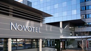 A modern hotel with a glass facade and the name 'Novotel' prominently displayed. - Novotel Annecy Centre (Annecy)