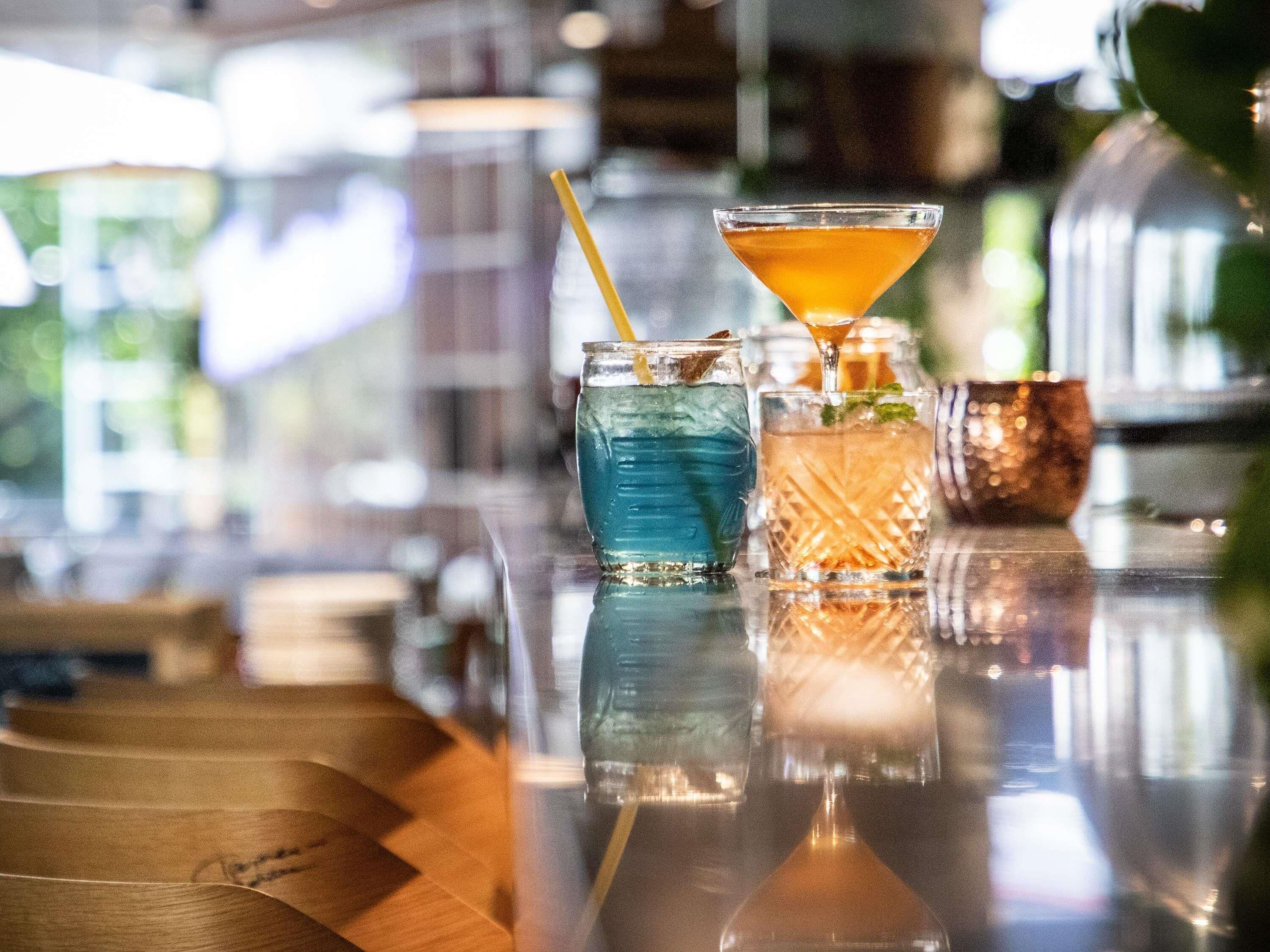 A bar area with various drinks and glasses.
