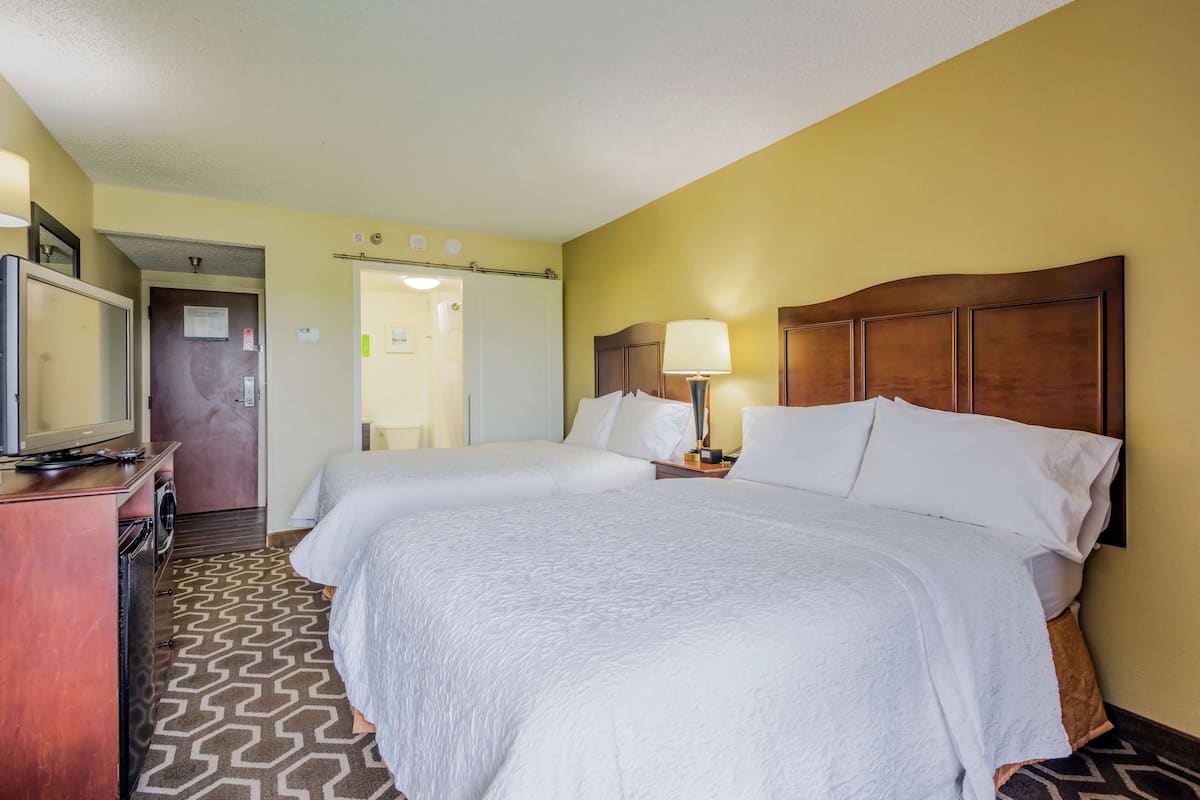 Premium bedding, desk, laptop workspace, blackout curtains