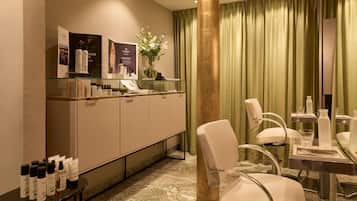 Relax in a stylish room with a glass display cabinet, comfortable seating area, and large mirror.