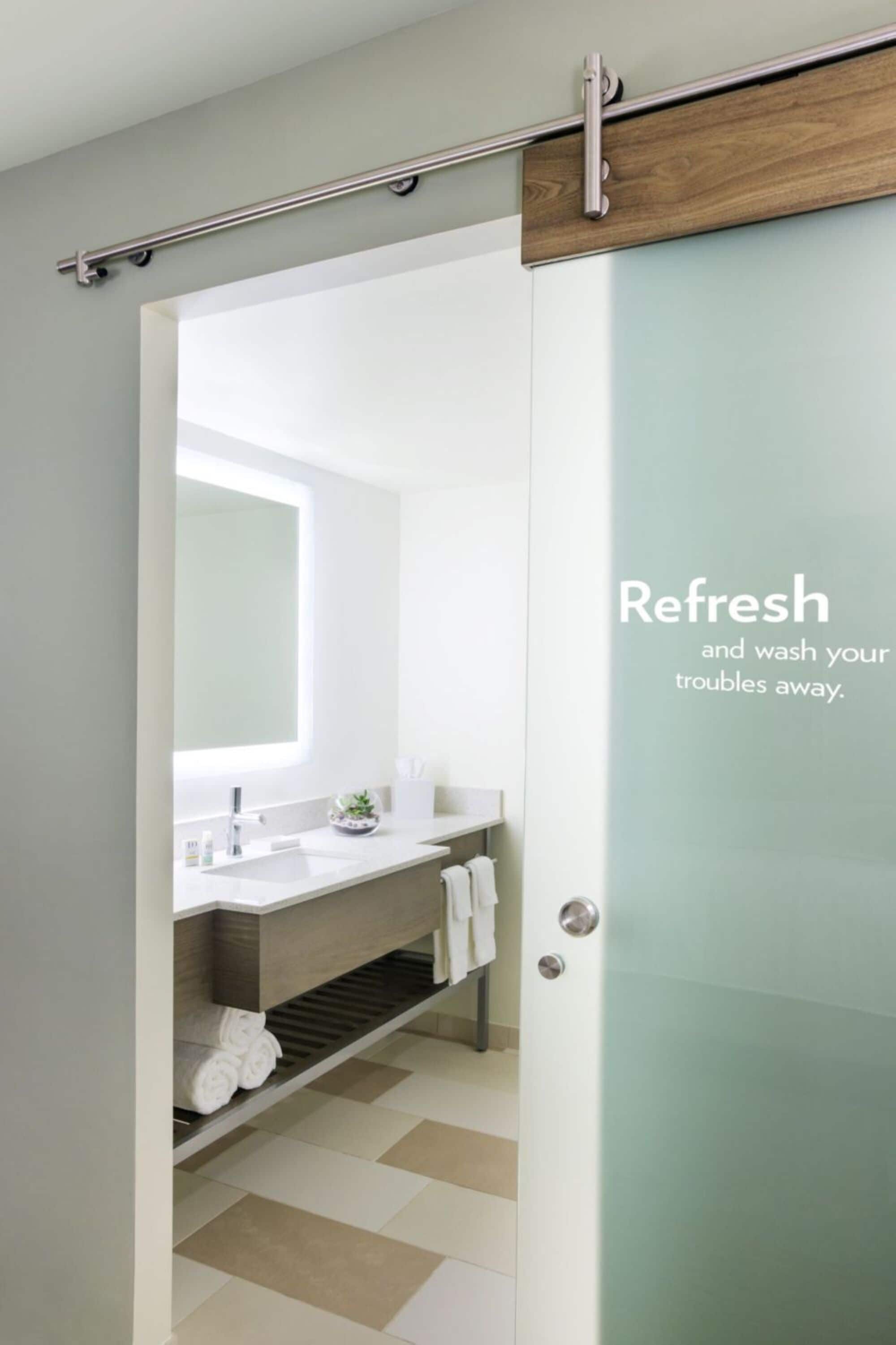 designer toiletries, hair dryer, towels