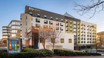 A multi-story hotel with a sign indicating it's part of the EVEN Hotels chain.