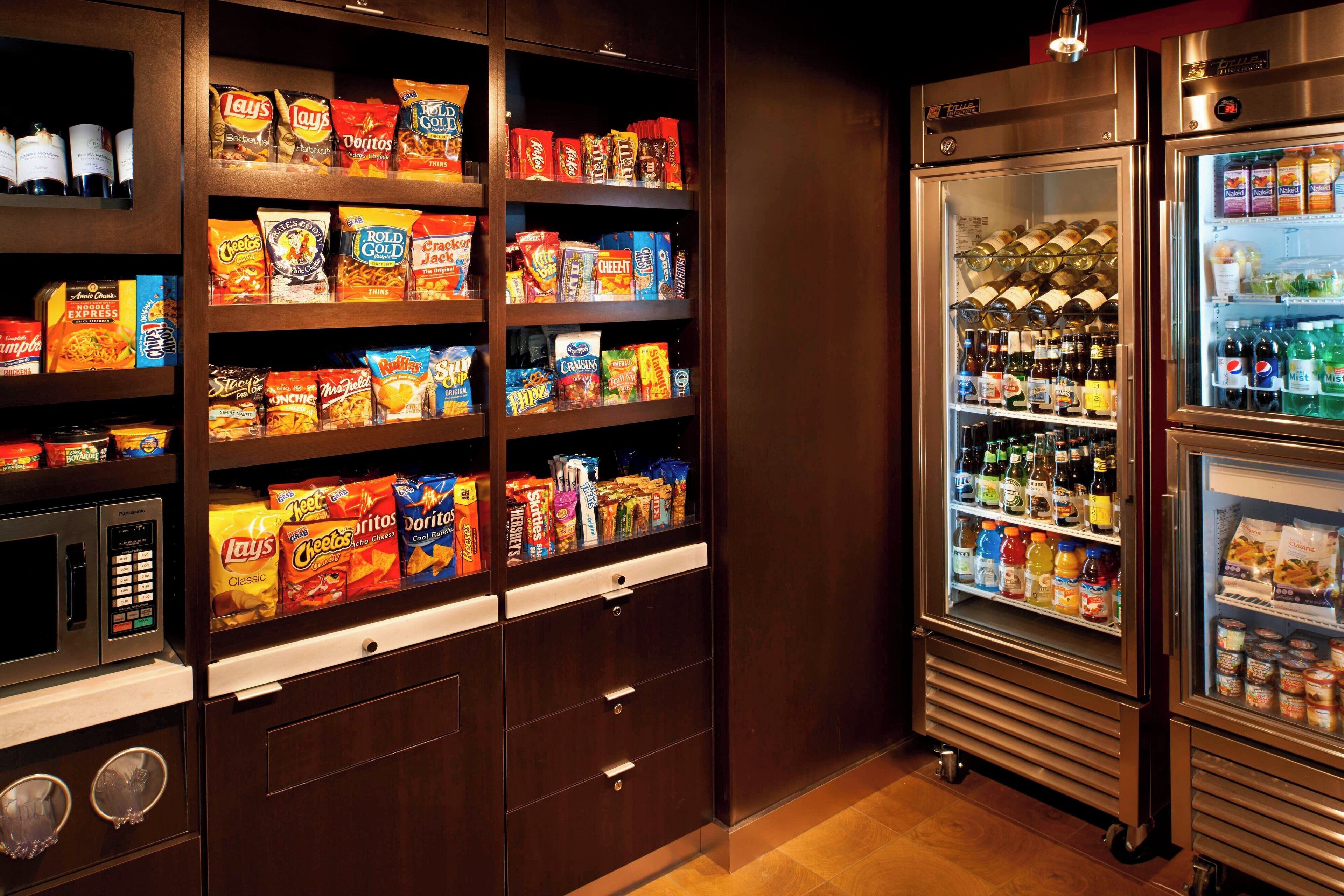 A vending machine stocked with snacks and beverages, including chips, sodas, and bottled drinks.