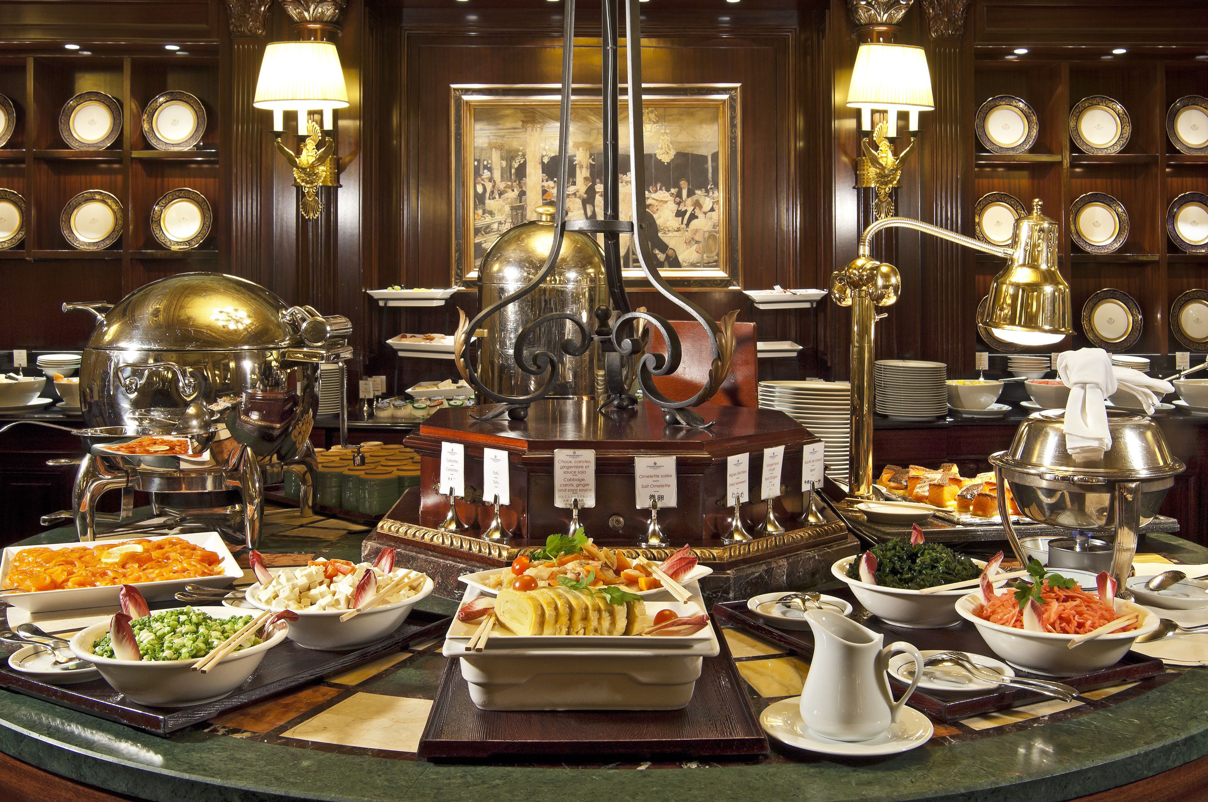 A buffet with various dishes and a central decorative item.
