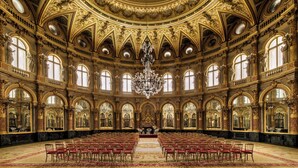 A grand hall with ornate gold detailing, large chandeliers, and rows of red chairs. - InterContinental Paris le Grand by IHG (Paris)