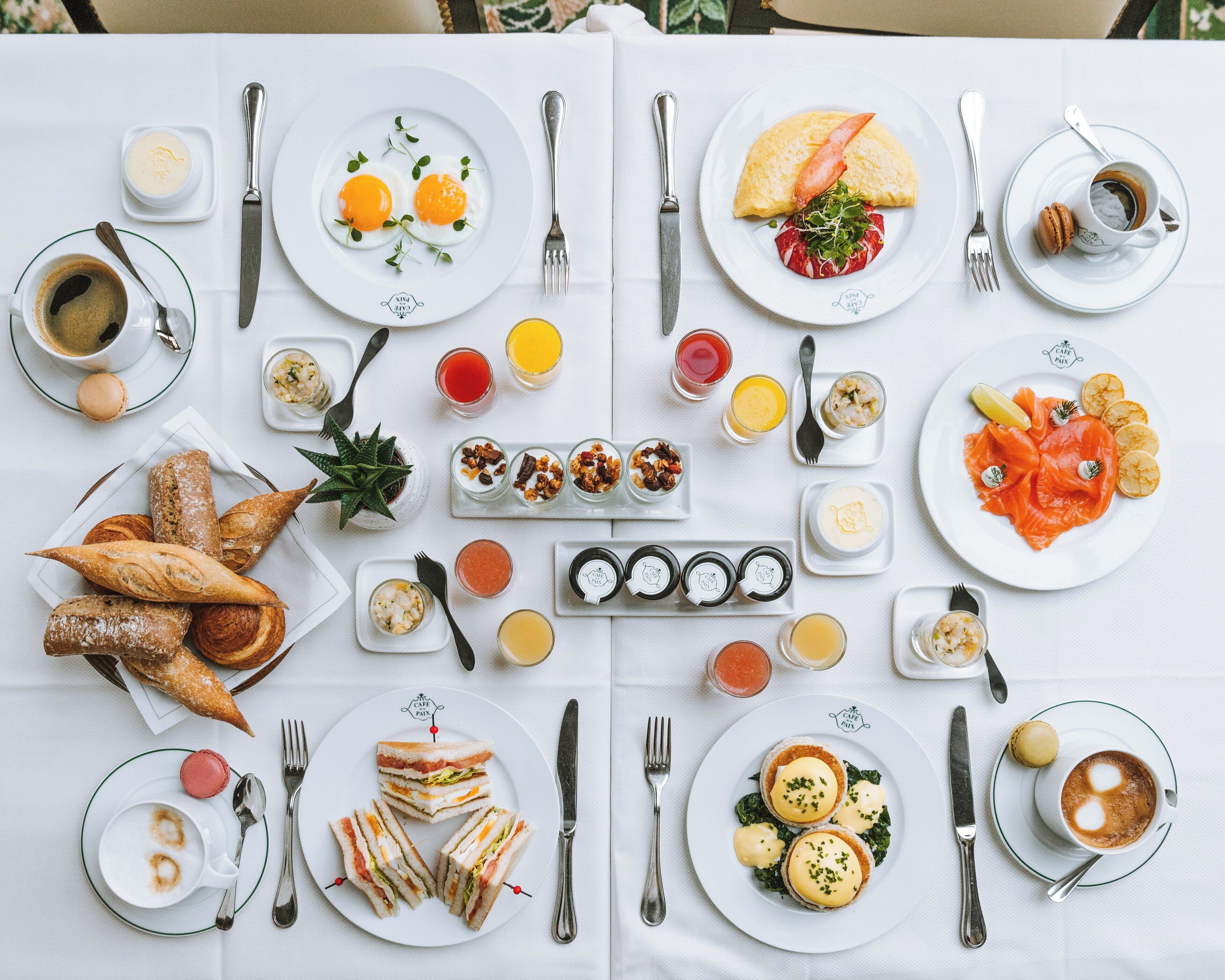 A breakfast buffet with various dishes and drinks.